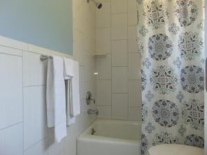 a bathroom with a tub and a shower curtain at Westbrook Motel in Abbeville