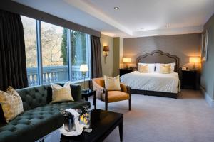 a large hotel room with a bed and a couch at Muckross Park Hotel & Spa in Killarney +39 photos