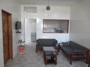 a living room with two couches and a table at Résidence Séjour Téranga in Saint-Louis