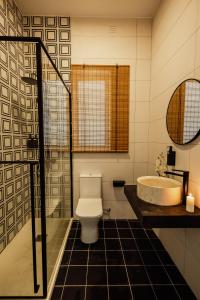 a bathroom with a toilet and a sink and a tub at St Julians`s Urban Apartments in Is-Swieqi +76 photos