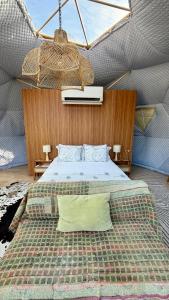 a bedroom with a bed in a tent at Soul Forest GeoDome - Off-grid Nature Escape in Sedgefield