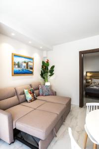 a couch in a living room with a table at Akrogiali Apartments in Bali