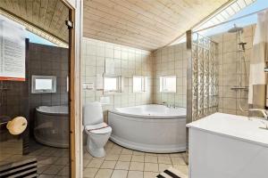 a bathroom with a tub and a toilet and a sink at OH287-Hadsund-Haslevgarde-Eng-1 in Hadsund +14 photos