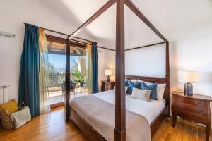 a bedroom with a canopy bed and a window at Cagliari Bay View Villa in Quartu Sant'Elena