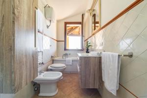 a bathroom with a toilet and a sink and a mirror at Cagliari Bay View Villa in Quartu Sant'Elena +35 photos