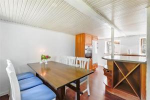 a dining room and kitchen with a wooden table and chairs at OH397-Storvorde-Kystvej-171 in Storvorde