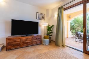 a living room with a flat screen tv on a dresser at Cagliari Bay View Villa in Quartu Sant'Elena