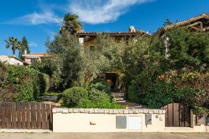 a house with a fence in front of it at Cagliari Bay View Villa in Quartu Sant'Elena