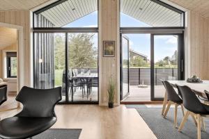 a dining room with a table and chairs at OH419-Hadsund-Halvrebene-60 in Hadsund +21 photos