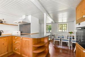 a kitchen with a counter and a dining room at OH397-Storvorde-Kystvej-171 in Storvorde