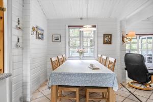 a dining room with a table and chairs at OH357-Storvorde-Hybenvej-40 in Storvorde +15 photos