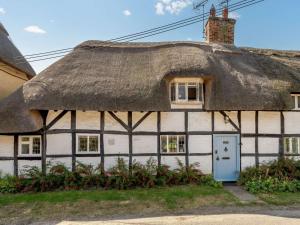 an old thatched cottage with a blue door at 2 Bed in Salisbury oc-88922 in Boreham