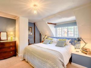 a bedroom with a large bed and a window at 2 Bed in Salisbury oc-88922 in Boreham