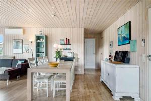 a kitchen and living room with a table and chairs at OH359-Storvorde-Kongeornen-62 in Storvorde
