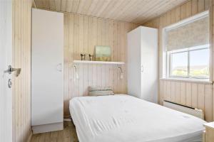 a small bedroom with a bed and a window at OH359-Storvorde-Kongeornen-62 in Storvorde