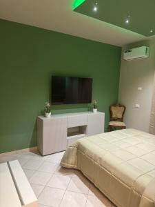 a bedroom with a bed and a flat screen tv at Angel house airport in CTA