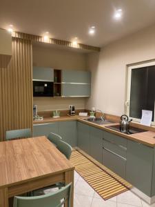 a kitchen with a counter and a table with chairs at Angel house airport in CTA