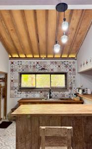 a kitchen with a wooden counter and a window at Omah Ndoro Sugih in Serut