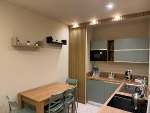 a kitchen with a wooden table and chairs in a room at Angel house airport in CTA +15 photos