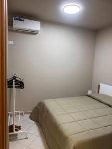 a bedroom with a bed and a air conditioner on the wall at Angel house airport in CTA