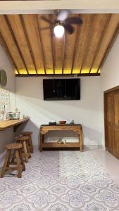 a living room with a table and a flat screen tv at Omah Ndoro Sugih in Serut
