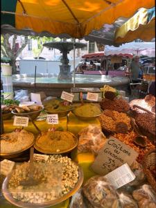 a market with many different types of food on display at La petite hostellerie in Uzès +51 photos