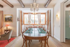 a dining room with a table and chairs and a chandelier at Gästehaus Eltz - Your Austrian Home in Puchen