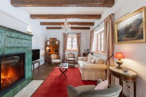 a living room with a fireplace and a red rug at Gästehaus Eltz - Your Austrian Home in Puchen