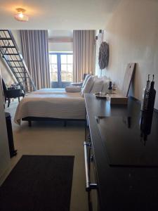 a bedroom with a bed and a desk with a sink at De Citadel - De Boomgaard in Markelo