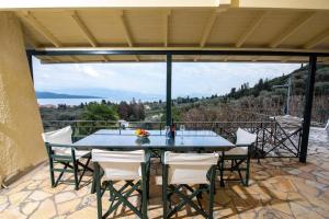 a table and chairs on a patio with a view at Nikiana Panorama in Nikiana