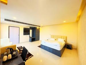 a bedroom with a bed and a living room at Hotel Ranjana Palace in Pūrnia
