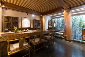 a dining room with a large table and chairs at 见天会馆 in Lijiang +16 photos