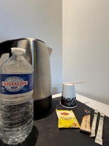 a bottle of water sitting next to a slow cooker at Bio-Motel in Saint-Vulbas
