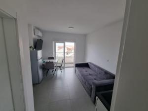 a living room with a couch and a table at Apartments Pool Villa Maria, Novalja in Novalja
