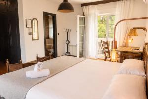 a bedroom with a large bed with a towel on it at Hotel El Balcon de las nieves in La Zubia +119 photos