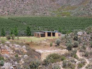 an aerial view of a house in the middle of a field at Klipspringer Cottage in Prince Alfreds Hamlet