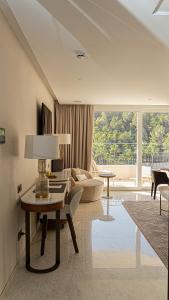 a living room with a table and a couch at ZEM Wellness Clinic Altea - 5 Stars Grand Luxury in Altea