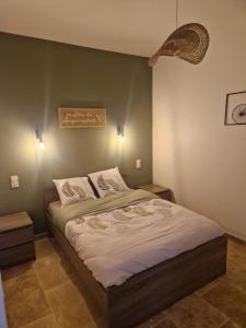 a bedroom with a large bed with two night stands at Gîte pour 2 personnes in Le Bugue