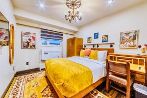 a bedroom with a king sized bed and a desk at Neocolonial Nouveau Kensington Vacation Home in Vancouver