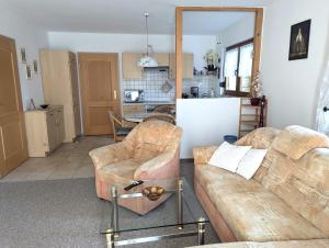 a living room with two couches and a kitchen at Ferienwohnung Törpsch in Pirna
