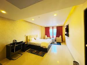 a bedroom with a bed and a television in it at Hotel Ranjana Palace in Pūrnia