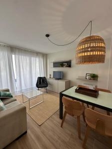 a living room with a table and a couch at Piso en el corazón de Baiona con vistas al mar in Baiona