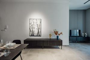 a living room with a table and a picture on the wall at St Julians`s Urban Apartments in Is-Swieqi