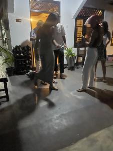 a group of people dancing in a room at Ryo hostel in Ahangama