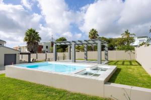 a swimming pool in the backyard of a house at Nova Haus in Plettenberg Bay
