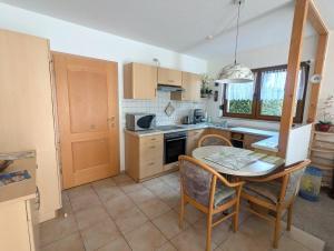 a kitchen with a table and a table and chairs at Ferienwohnung Törpsch in Pirna