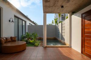 an outdoor patio with a hot tub and a bench at Two Seasons Siem Reap Hotel in Siem Reap