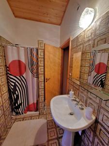 a bathroom with a sink and a shower at White Cottage - WelcHome in Mozzagrogna +23 photos