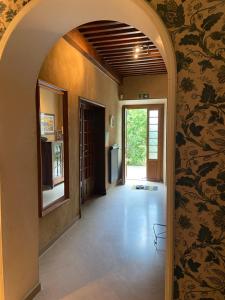 an archway leading to a hallway with a kitchen in a house at Le Colombier d'Antan in Les Vans