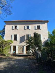 a large stone building with windows on top of it at Le Colombier d'Antan in Les Vans